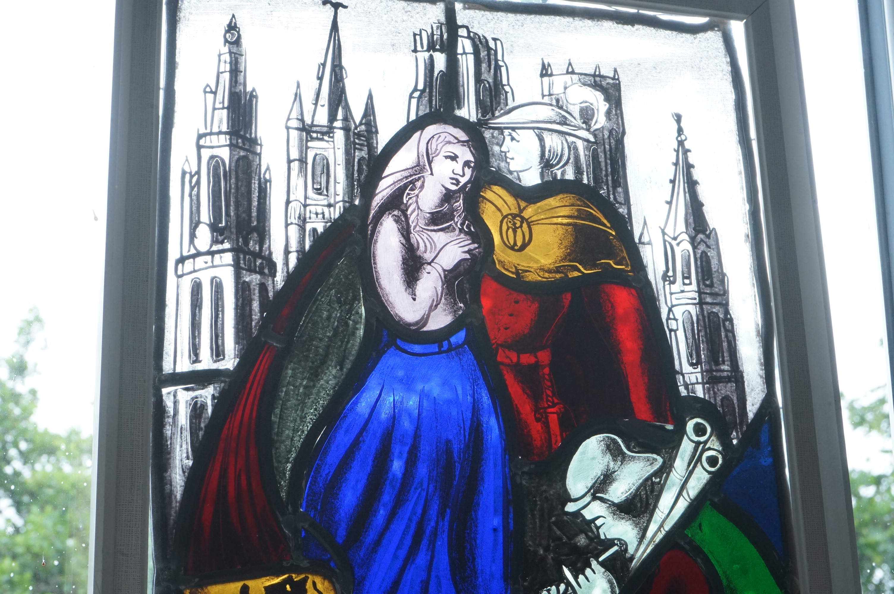 A stained and leaded glass panel of a romantic couple in front of a cathedral, 48cm high